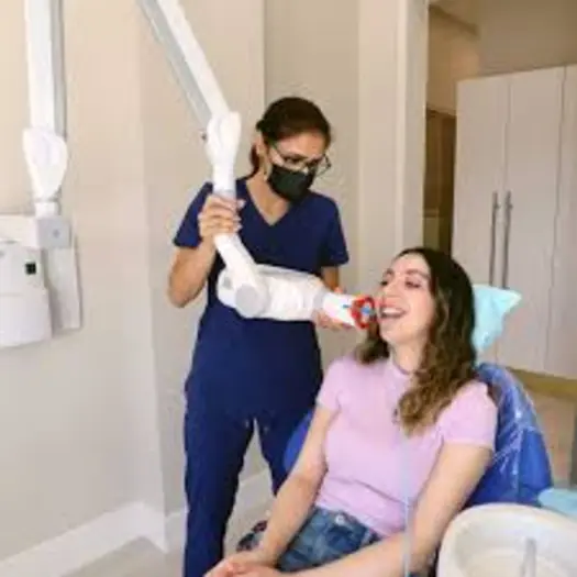 Dentist taking bitewing X-ray of patient at Nick Dental clinic